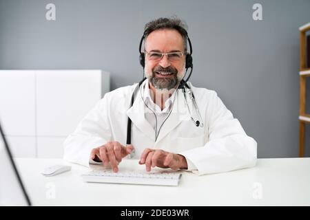 Senior Older Man Doctor Computer Video Conference Stock Photo