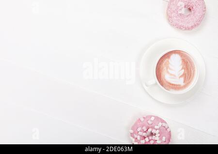 Flat lay composition with donuts and cup of coffee on white background Stock Photo