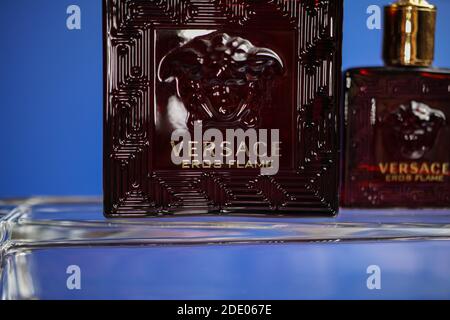 Viersen, Germany - May 9. 2020: Close up of isolated Versace eros flame men perfume flacon in on glass, blue background