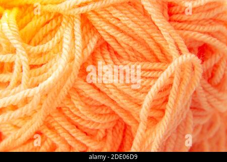 Tangled wool texture. Textured background of bright orange threads Stock Photo