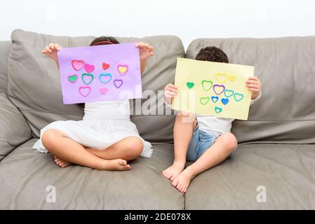 Children Holding Hand Made Gift Card With Love Heart Shape. Stock Photo