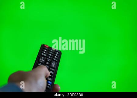 TV remote control on green chroma screen Stock Photo