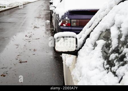 snow covers parked cars on city street Stock Photo - Alamy
