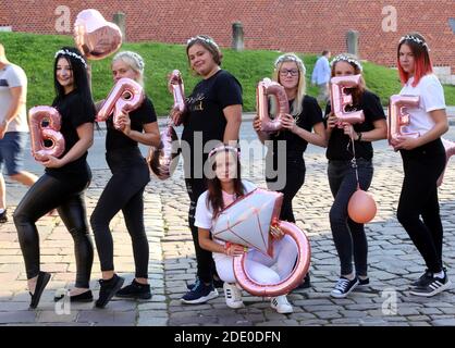 Cracow. Krakow.Poland. Group of young women posing for the picture in the street holding letter shaped baloons making up word 'Bridee' and one baloo Stock Photo