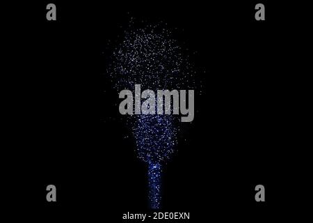 Explosion or burst of glossy sparkling blue glitter isolated on black background. Art Banner with copy space Stock Photo