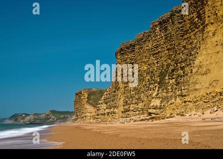 A view along the Jurassic Coast on the Dorset Coast in front of Burton Cliff close to Burton Bradstock. Part of the South West Coast Path. Stock Photo