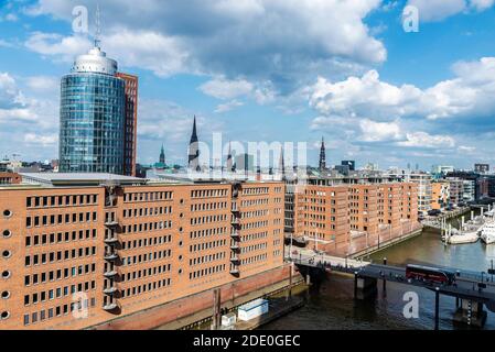 Hamburg, Germany - August 21, 2019: Overview of the Hanseatic Trade Center (HTC) and Columbus Haus, modern office building with people around in Hafen Stock Photo