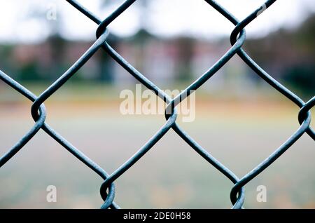 Geometrical grey-green wire fence in close-up at tennis court Stock Photo
