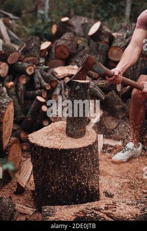 One big, muscly guy chop wood Stock Photo