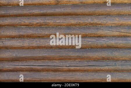 Rough wooden beams background, brown log wall texture close-up for building design. Stock Photo
