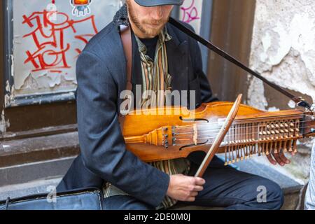 Music street man playing a Nyckelharpa a traditional Swedish musical ...