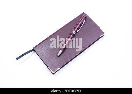 Purple Pen and Purple Cover Notebook on white Background Stock Photo