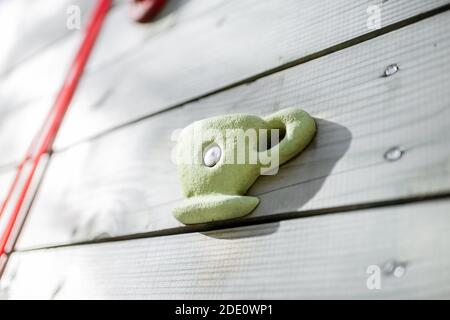 Climbing grips on the artificial climbing wall, close-up Stock Photo