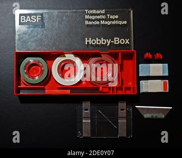BASF Hobby Box with a knife and cutting plate to cut magnetic tapes  In this box are three roles of leader tape (colors green, white, red ) Stock Photo