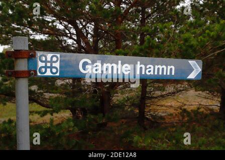 Sign post with direction to the old medievial harbor, Gamle hamn, located at the Faro island in the Swedish province of Gotland. Stock Photo