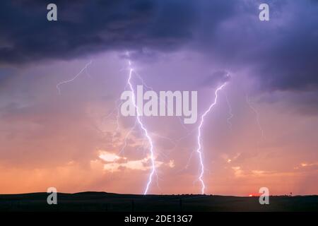 Lightning bolts and dramatic stormy sky at sunset near Sparks, Nebraska Stock Photo