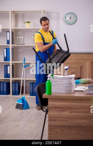 Male contractor cleaning the office Stock Photo