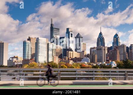 Skyline with cyclist on South Street Bridge riding towards University City , Philadelphia, Pennsylvania, USA Stock Photo