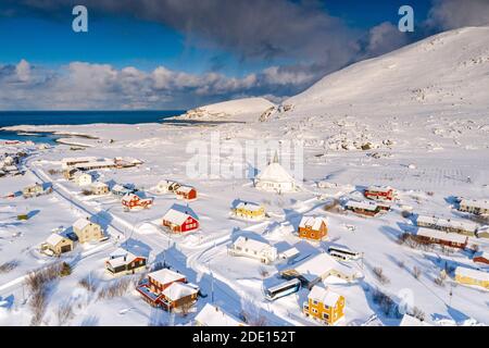 Aerial view of the fishing village of Hasvik covered with snow in winter, Soroya Island, Troms og Finnmark, Northern Norway, Scandinavia, Europe Stock Photo