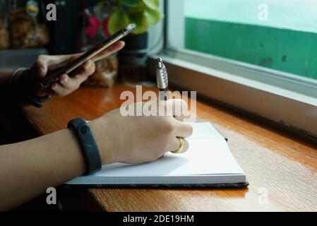 She was working to note order from a customer in the cafe. Stock Photo