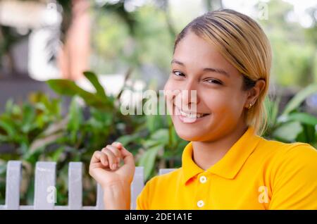 young woman 20 to 30 years in different expressions in front of the camera in a park Stock Photo