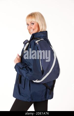 Young woman with a rucksack on an isolated studio background Stock Photo