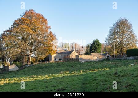 Cotswold stone house in autumn afternoon sunlight in the village of Sherborne, Cotswolds, Gloucestershire, England Stock Photo