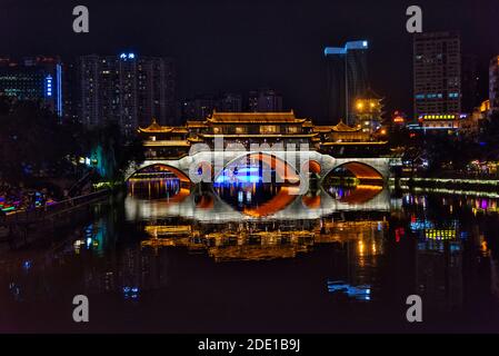 Night view of Anshun Bridge across the Jin River with reflection in the water, Chengdu, Sichuan Province, China Stock Photo