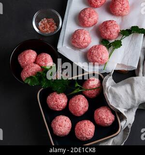 Fresh raw meatballs with herbs. Stock Photo