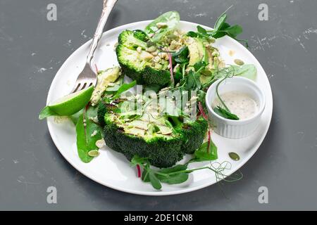 Green broccoli salad with white sauce. Helathy food concept. Stock Photo