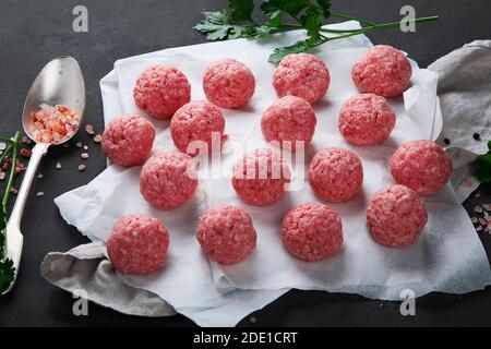 Fresh raw meatballs with herbs. Stock Photo