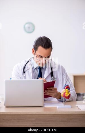 Young doctor lecturer cardiologist working in the clinic Stock Photo