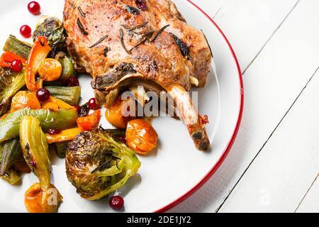 Grilled roasted rack of pork on plate.Baked meat with different vegetables Stock Photo