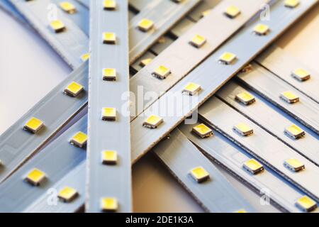 Pile of Led smd screen strip on white background. Diode strip. LED lights tape pattern. Selective focus, shallow depth of field Stock Photo