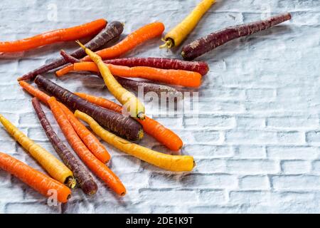 Baby rainbow carrots on a white background - high angle view Stock Photo