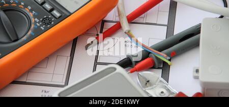 Sockets with a screwdriver and a measuring device on a circuit diagram Stock Photo