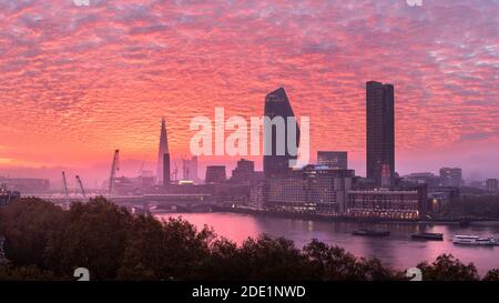 Epic sunrise over London city skyline with stunning sky formations over iconic landmarks Stock Photo