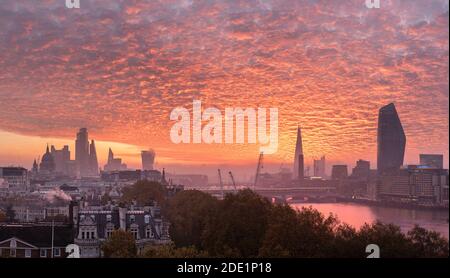 Epic sunrise over London city skyline with stunning sky formations over iconic landmarks Stock Photo