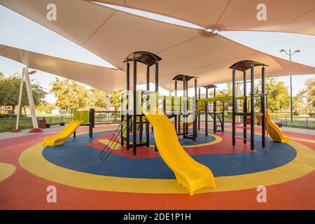 Shaded kid's playground activity tower equipment at the Lake park in Abu dhabi Stock Photo