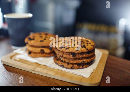Tasty cookie at bar counter in coffee shop. Blurred image, selective focus Stock Photo