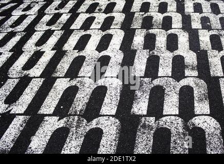 Letter m painted on the asphalt, sign detail, decoration Stock Photo