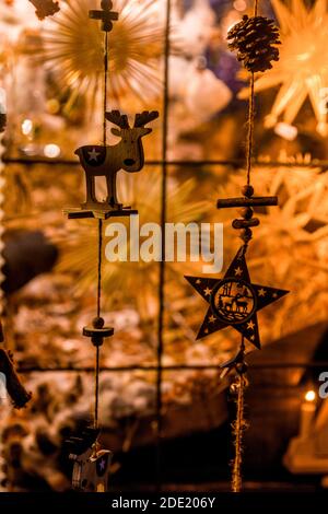 Christmas decorations hanging in a backlit window Stock Photo