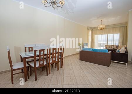 Living room lounge area in luxury apartment show home showing interior design decor furnishing with balcony and dining table Stock Photo