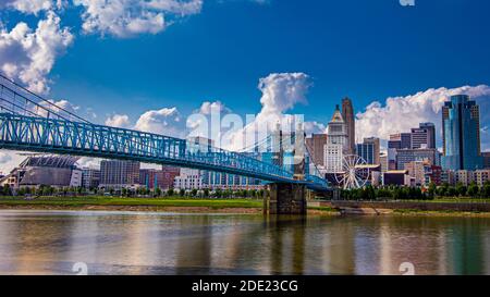 Cincinnati, OH--Aug 26, 2018; blue steel and stone John A. Roebling Suspension Bridge over Ohio River with downtown skyline Stock Photo