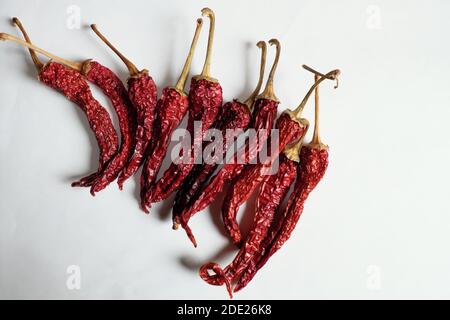 A lot of red peppers on a white background. Stock Photo