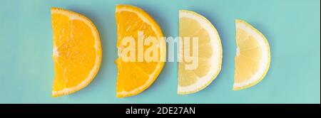 Lemon and orange slices arranged in a row on a pastel blue background. Healthy food and citrus Stock Photo