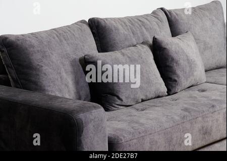 Soft pillows on grey sofa close up view isolated Stock Photo