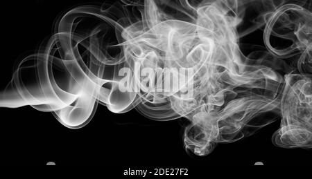 Cloud of grey smoke swirls isolated on black background Stock Photo