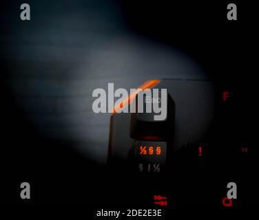 Esc or escape button on a gaming keyboard in the dark, close up.  Stock Photo