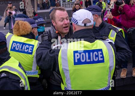 Kings Cross Station, London, UK. 28th Nov, 2020. A protest is taking place against the lockdown restrictions in place for the COVID 19 Coronavirus pandemic. Despite the Metropolitan Police issuing a statement to remind protesters that such a gathering would be unlawful during the current regulations many still attended. Some gathered outside Kings Cross station where an arrest was made Stock Photo